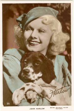 an old photo of a woman holding a dog