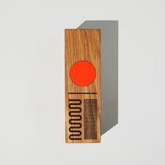 a wooden object with an orange circle on it