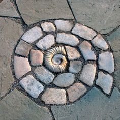 a stone walkway with a spiral design on it