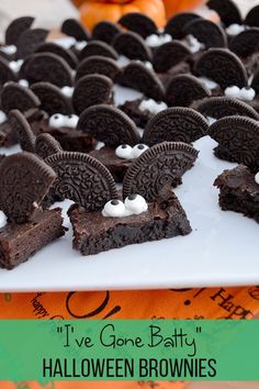 chocolate brownies with white frosting in the shape of oreos on a plate