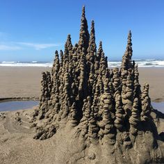 a sand castle made out of rocks on the beach