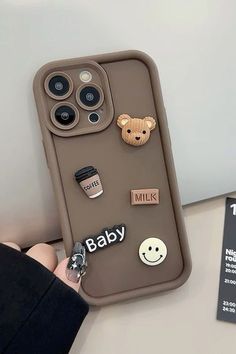 someone is holding up their phone case with some cute things on it