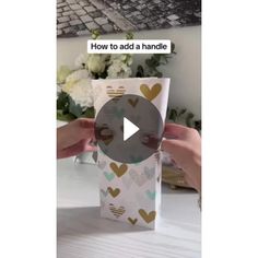 someone holding up a box with hearts on it and the text how to add a handle