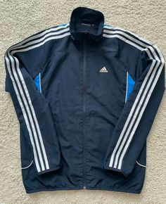 Adidas Blue Outerwear With Three Stripes Branding, Adidas Blue Outerwear With Three Stripes, Adidas Blue Track Jacket With Three Stripes, Adidas Long Sleeve Track Jacket With Three Stripes, Navy Adidas Track Jacket For Sports, Adidas Navy Track Jacket For Sports, Navy Adidas Long Sleeve Track Jacket, Adidas Navy Long Sleeve Track Jacket, Adidas Long Sleeve Outerwear With Three Stripes