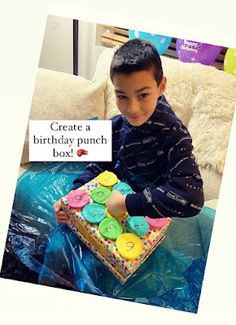 a young boy sitting on a couch with a birthday cake in front of him that says create a birthday punch box