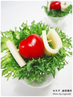 two small bowls filled with lettuce, tomatoes and cheeses on top of each other