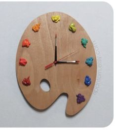 a wooden clock with colorful candies painted on it's face and the hands