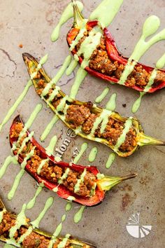 stuffed peppers with meat and green sauce drizzled over them