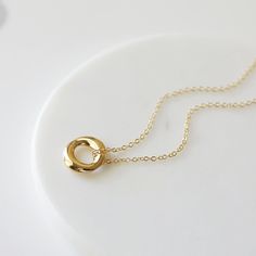 "Beautiful and lovely gold pendant necklace. Made of small gold circle pendant with skinny gold plated brass chain. Soft and warm. Great for gift, everyday or special occasion. Your item will ship in a gift box. Please feel free to contact me if you have any question. ♥ Length 15\" - 20\" ♥ Pendant 5/8\" ♥ Gold plated over brass ♥ See more Rudiana Accessories Rudiana.etsy.com" Everyday Yellow Gold Circle Charm Necklace, Simple 14k Gold-filled Charm Necklaces, Simple Gold Charm Necklace 14k Gold Filled, Simple Gold Charm Necklace In 14k Gold Filled, Gold Circle Charm Necklace For Gift, Simple Gold Charm Necklaces For Everyday, Simple Everyday Gold Charm Necklaces, Gold Circle Minimalist Charm Necklace, Minimalist Circle Charm Gold Necklace