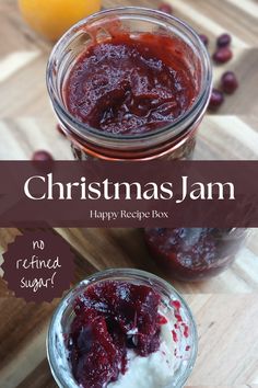 two jars filled with jam sitting on top of a wooden table next to an orange