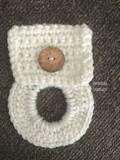 a crocheted object with a wooden button on it