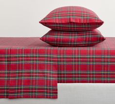 red plaid sheets and pillows on a bed