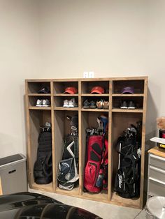 a golf bag is sitting in the corner of a room next to a shelf filled with golf gear