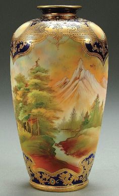 an ornate vase painted with mountains and trees