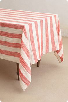 a red and white striped table cloth on top of a wooden chair