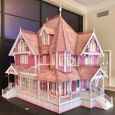 a paper model of a pink victorian house