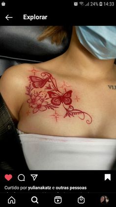 a woman's chest with flowers and butterflies tattooed on her shoulder, while wearing a surgical mask