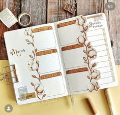 an open planner book sitting on top of a wooden table