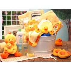 a baby shower gift basket with yellow rubber ducky toys and personal care items in it