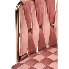 an upholstered pink velvet chair with gold metal frame and back rests on a white background