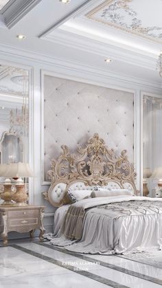 a large white bed sitting in a bedroom next to a chandelier and two lamps