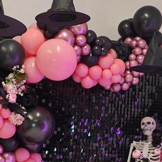 there is a skeleton sitting in front of some balloons