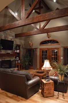 a living room with couches, chairs and a fireplace