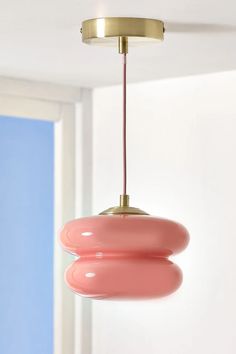 a pink light hanging from a ceiling in a room