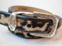 Stylish skinny leather belt from Brighton, vintage 1990s. Features leopard / cheetah print on calf hair backed with cowhide leather. Trimmed with black and silvertone hardware. Women's S (28).Measures 3/4" wide; strap is 30" long, 24" to first hole, 28" to the last.Excellent condition. No signs of wear.Smoke free, pet freeMADE IN THE USA Y2k Belt Buckle, Vintage Brown Belt With Antique Buckle, Cheetah Print Leather Belt, Brown Belt Silver Buckle, Ralph Lauren 90s, Brighton Shops, Western Costumes, Vintage Brown Hand-tooled Belt Buckle, Braided Leather Belt