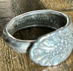 a silver ring sitting on top of a wooden table