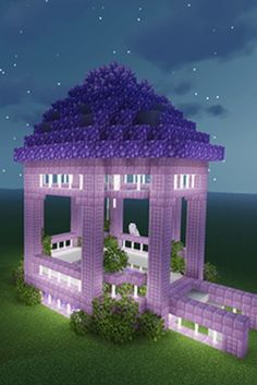 a purple house is in the middle of some grass