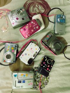 many different types of cameras on a bed