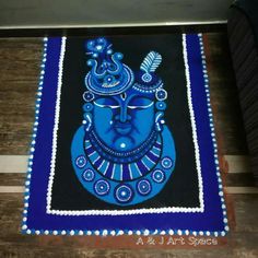 a blue and black mat with an image of the face of lord ganesha on it