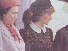 two women standing next to each other in front of a man wearing a red hat