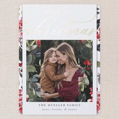 a christmas card with an image of two women hugging and the words merry on it