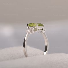 ◆ Featuring the dainty peridot in the shape of emerald, clear cubic zirconia like the angel wings appear on the sides of the green gemstone. A piece fits for elegance, suitable for engagement, party, daily occasion. ◆ Production Description: Main stone Type: Peridot Main Stone Shape: Emerald Main Stone Size: 6*8mm Side stone: CZ Metal: 925 Sterling silver - Other options available in the drop down menu ◆ Customization: √Free for Add Engraving √Other Metal Type Available √Other Gemstones & Sh Trillion Cut Green Diamond Ring, Green Emerald Ring With Diamond Accents In Sterling Silver, Green Diamond Rings With Trillion Cut, Green Birthstone Ring With Diamond Accents, Peridot Three Stone Jewelry As Gift, Sterling Silver Green Diamond Ring With Accents, Three Stone Peridot Jewelry As Gift, Green Diamond Open Ring, Green Peridot Three Stone Jewelry