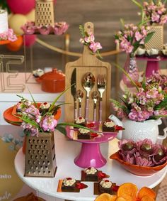 a table topped with lots of desserts and flowers