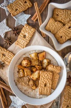 a bowl of oatmeal with cinnamon cookies and star anise on the side