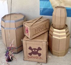 cardboard boxes are stacked on top of each other near flowers and wine barrels in front of a building