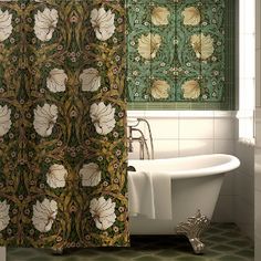 a bath tub sitting under a window next to a shower curtain with flowers on it