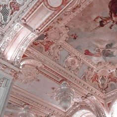 an ornate ceiling with paintings and chandeliers