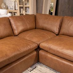 a large brown leather sectional sofa in a living room