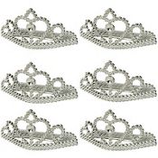 six pieces of silver metal tiables, each with a small crown on top