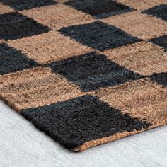 a close up view of a brown and black rug with squares on the bottom side