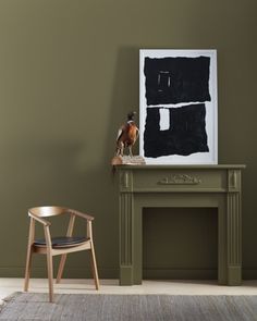 a living room with a chair, table and painting on the wall next to it