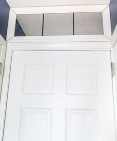 an open white door with blue trim on it