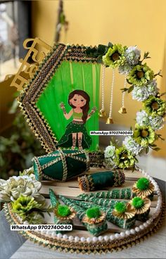 a table topped with green and gold decorations