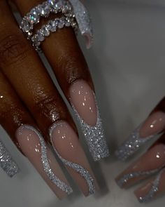 a woman's nails with glitter on them