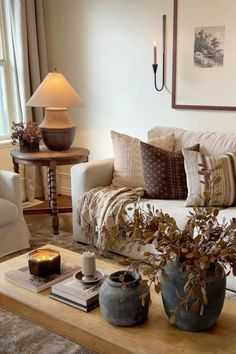 a living room filled with lots of furniture and decor on top of a wooden table