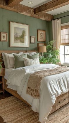 a bedroom with green walls and white bedding in the center is decorated with pictures on the wall